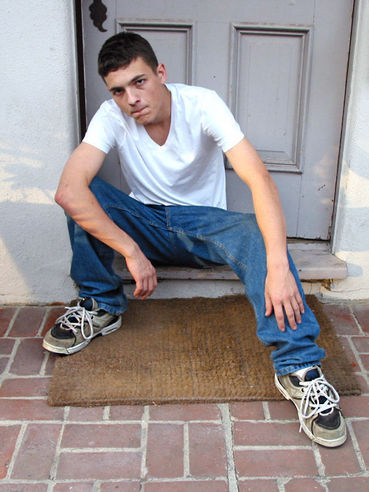 Young David takes off his dirty sneakers & his stinky white socks to show off his large feet
