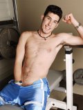 Black haired 20 year old guy Rick Ravishing poses topless in tight jeans and blue shorts