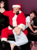Older man in Santa Claus costume is spanking and fucking young slender TJ Wood