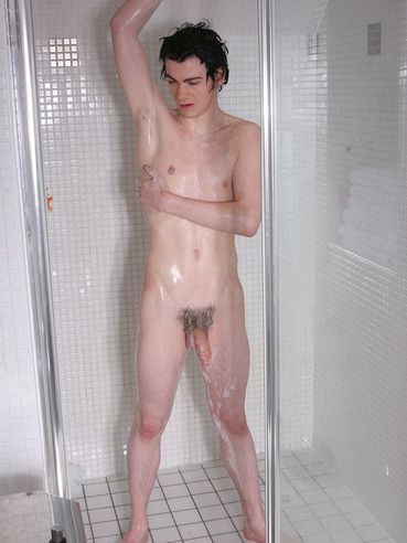 Wet boy Orlando Bacon with wet black hair plays with his snake in the shower