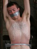 Sebastian Kane's tape gagged twink slave Luke Desmond has his chest covered in wax